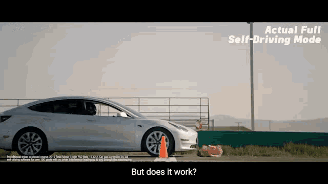 a tesla model 3 is driving on a road with a cone in front of it