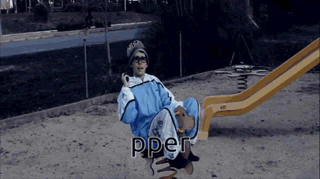 a person sitting on a seesaw with the word pper written on it