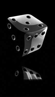 a black dice with holes in it is on a black background .