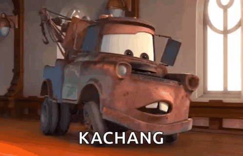 a tow truck from the movie cars is sitting in a room with the word kachang written on it .