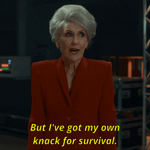 an older woman in a red suit says but i 've got my own knack for survival
