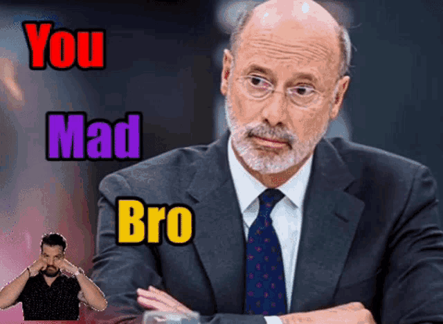 a man in a suit and tie with the words " you mad bro " behind him