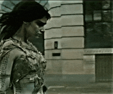 a woman in a mummy costume walking down a street