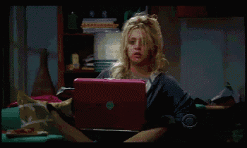 a woman is sitting in front of a laptop that has the letter c on it