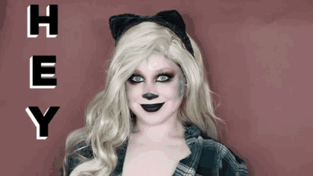a woman is wearing a cat costume and says hey