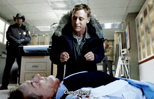 a man standing next to a man laying on the floor with the words clung clung