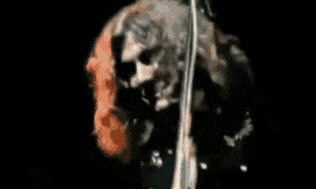 a close up of a person playing a violin on a stage .