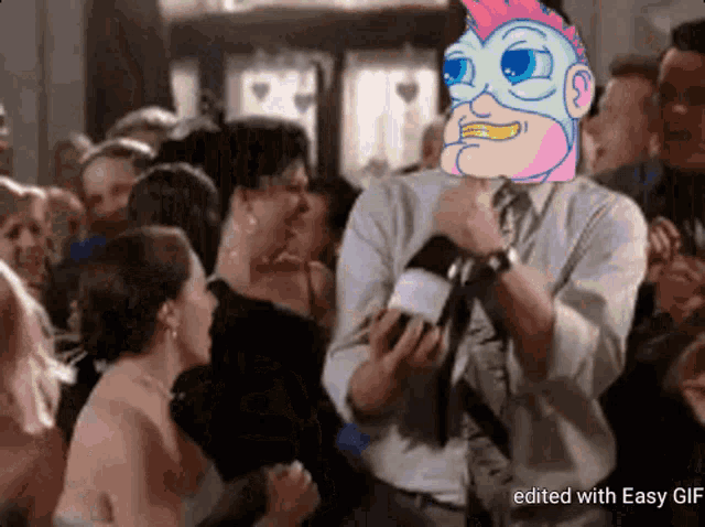 a man in a suit and tie is holding a microphone in front of a crowd with a cartoon character on his head