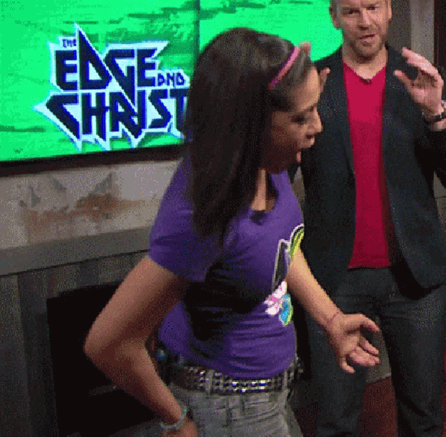 a woman in a purple shirt is dancing in front of a green screen that says the edge and chnst