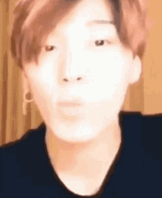a close up of a person 's face with a blurry background