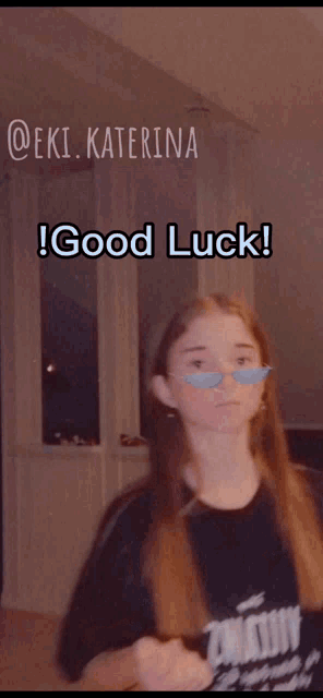 a girl with a fake mustache is wearing a t-shirt that says " good luck "