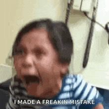 a little girl is crying with her mouth open and the words `` i made a freakin mistake '' written on the bottom .