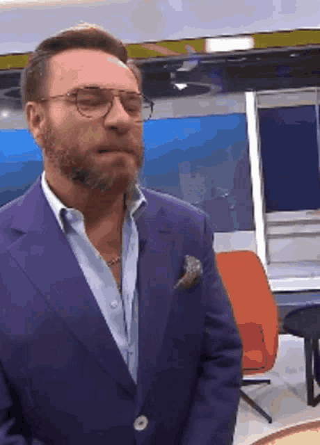 a man with a beard wearing a suit and glasses