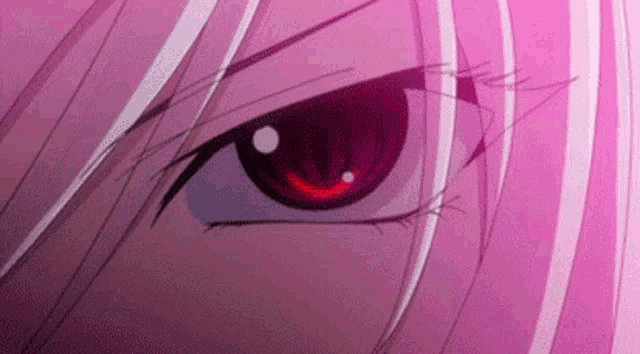 a close up of a person 's red eye with pink hair .