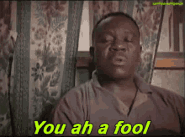 a man is sitting in a chair with the words you ah a fool on the screen