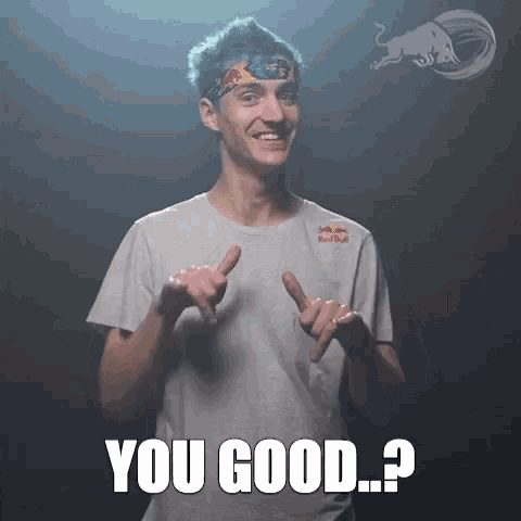 a man wearing a red bull shirt is giving a thumbs up sign
