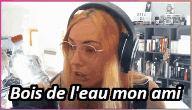 a woman wearing headphones and glasses is holding a bottle of water and says bois de l'eau mon ami