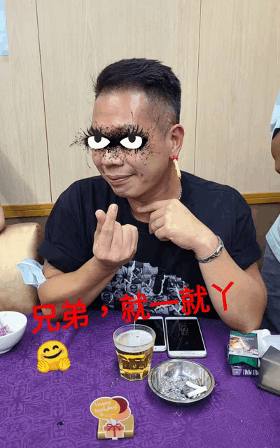 a man sitting at a table with a happy birthday sticker on the table