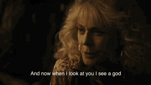 a woman says " and now when i look at you i see a god " in a dark room