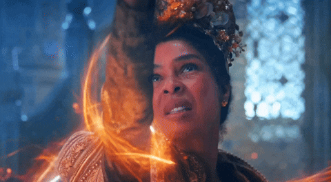 a woman with a crown on her head is surrounded by flames