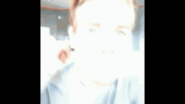 a man with red hair is making a funny face with his eyes closed