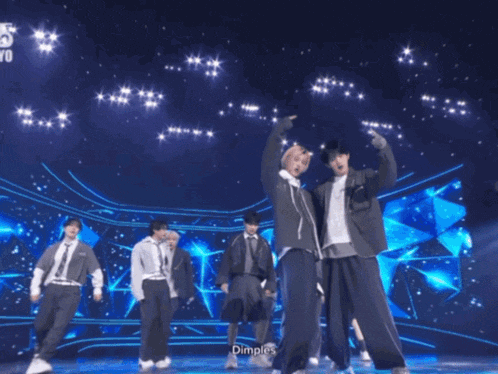 a group of young men are dancing on a stage and the word dimples is on the bottom right
