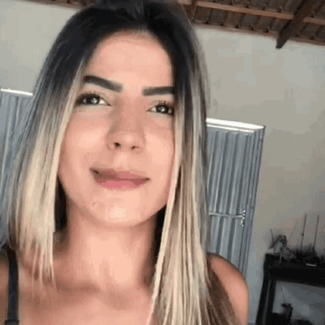 a close up of a woman 's face in a room