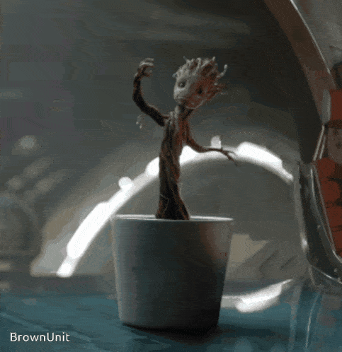 a statue of a tree in a pot with the words brown unit below it