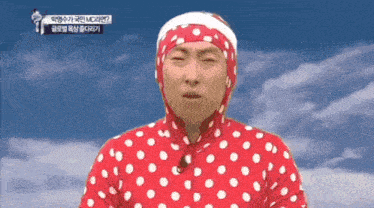 a man wearing a red and white polka dot outfit with a headband