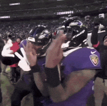 a football player wearing a purple jersey with the number 23 on it