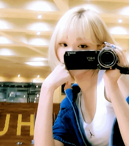a woman is taking a picture with a sony hd camera