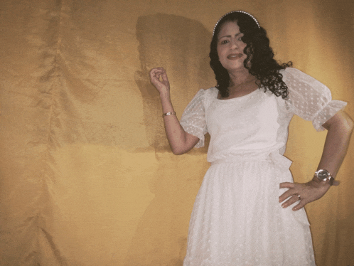 a woman in a white dress with a watch on her wrist