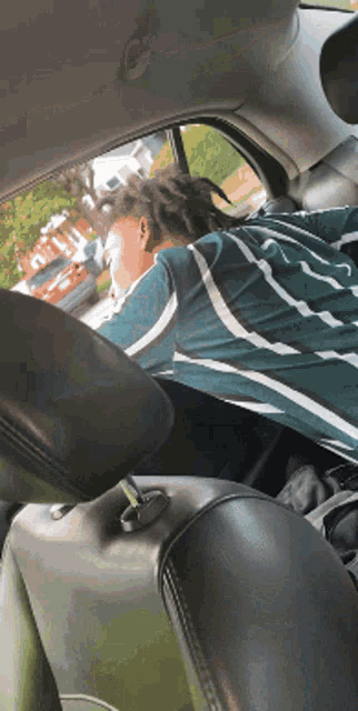 a person sitting in the back seat of a car