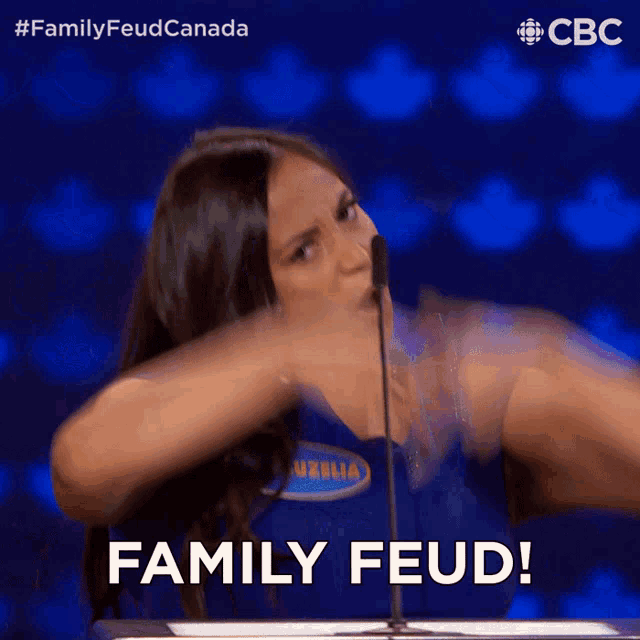 a woman speaking into a microphone with the words family feud behind her