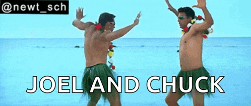 joel and chuck are dancing on the beach in hawaiian skirts