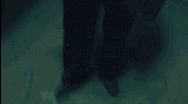 a person 's feet are shown in a dark room