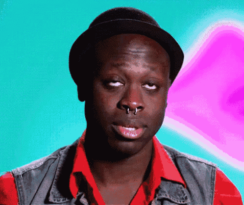 a man with a nose ring is wearing a hat
