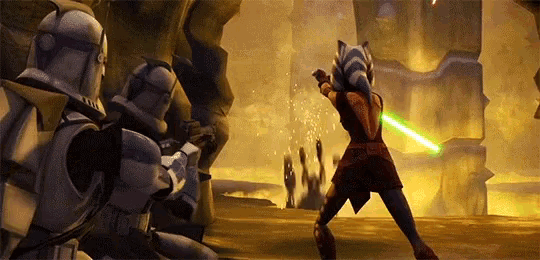 a woman is holding a green lightsaber while standing in front of a group of clone trooper soldiers .