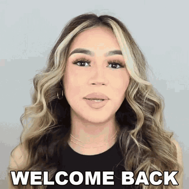 a woman says welcome back in front of a white background