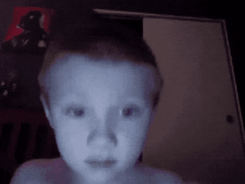 a child 's face is glowing in the dark