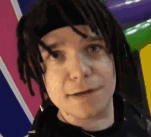a close up of a person 's face with dreadlocks and a headband