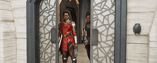 a man and a woman are standing in a doorway .