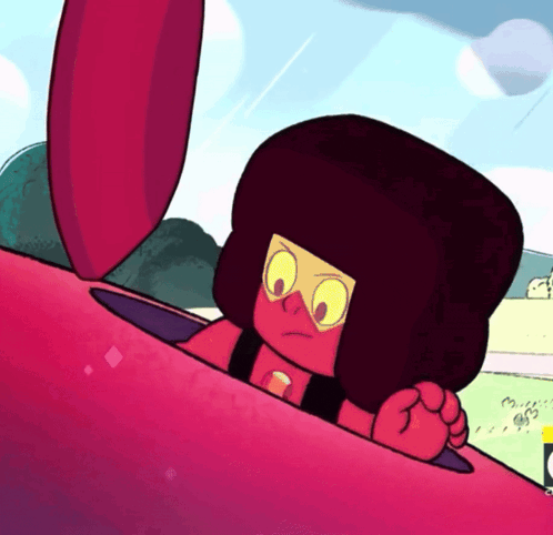 a cartoon character with red hair and yellow eyes looks out of a red object