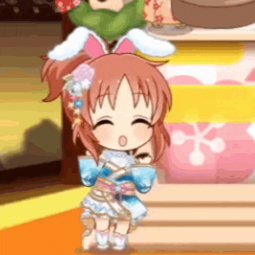a little girl in a blue dress with bunny ears is standing on a stage in front of a table .