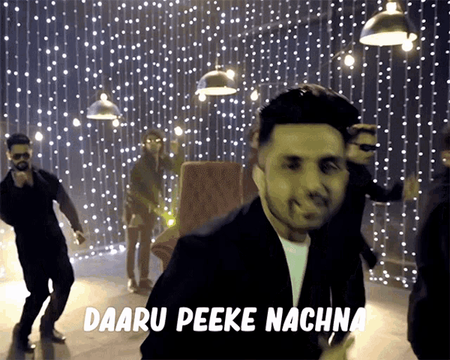 a group of men are dancing in a room with the words daaru peeke nachna written on the bottom