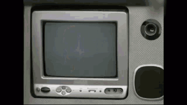 a small silver television with buttons and a speaker on the side