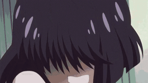 a close up of a girl with purple eyes and black hair making a funny face .