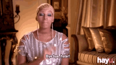 a woman in a silver dress is saying bye bye hater !