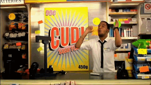 a man stands in front of a sign that says cud