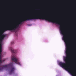 a blurry picture of a person with pink hair